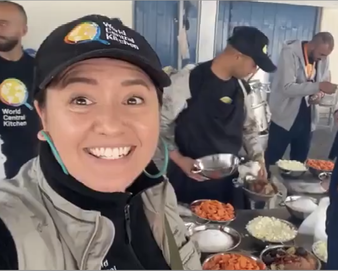 Australian World Central Kitchen (WCK) aid worker Lalzawmi "Zomi" Frankcom. She is wearing a baseball camp with WCK's logo and a gilet over a black sweatshirt. She is smiling.